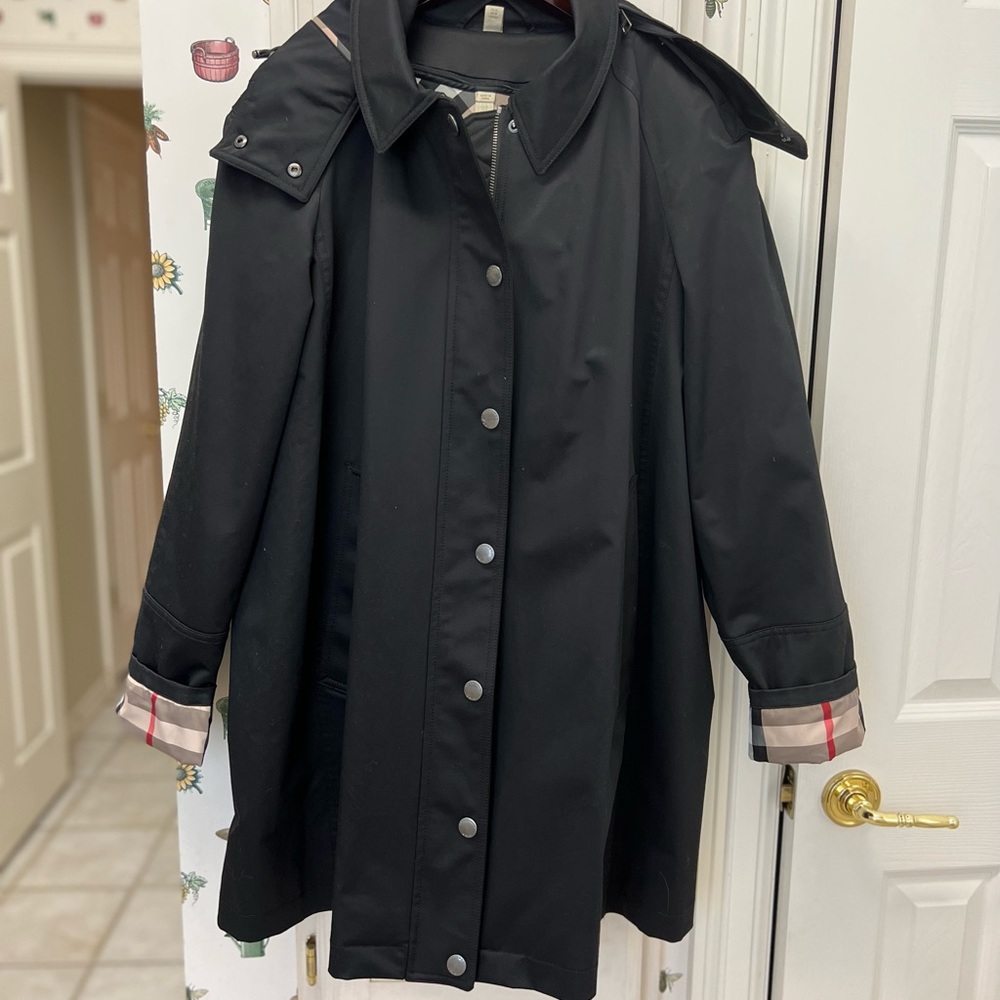 Burberry A-line trench coat with pockets.  Size 16US and black in color.
